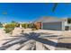 Residential home showcasing desert landscaping, a spacious driveway, and a single car attached garage at 14433 N 37Th St, Phoenix, AZ 85032