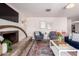 Comfortable living room featuring a brick fireplace, comfortable seating, and modern decor at 14433 N 37Th St, Phoenix, AZ 85032