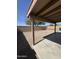 View of the covered patio and gravel backyard at 1606 S 226Th Dr, Buckeye, AZ 85326