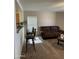 View of the living room and breakfast bar area with brown couches and barstools at 1606 S 226Th Dr, Buckeye, AZ 85326