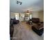 Wide angle view of living room, including the bar, kitchen and comfortable seating at 1606 S 226Th Dr, Buckeye, AZ 85326