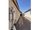 Narrow side yard with a stone pathway, gravel ground cover, and block wall fencing at 1606 S 226Th Dr, Buckeye, AZ 85326