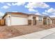 Charming single-story home with a brick driveway, two-car garage, and stone accents at 16804 W Yucatan Dr, Surprise, AZ 85388