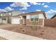 Charming single-story home featuring a two-car garage and decorative stone accents on the facade at 16804 W Yucatan Dr, Surprise, AZ 85388