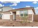 Charming single-story home featuring a two-car garage and decorative stone accents on the facade at 16804 W Yucatan Dr, Surprise, AZ 85388