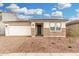 Charming single-story home featuring stone accents, a two-car garage, and low maintenance desert landscaping at 16804 W Yucatan Dr, Surprise, AZ 85388