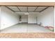 A large garage with an automatic door and concrete flooring at 16804 W Yucatan Dr, Surprise, AZ 85388