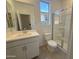 Clean bathroom featuring a single sink vanity and a glass-enclosed shower at 16954 W Molly Ln, Surprise, AZ 85387