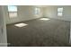 Spacious bedroom with carpet, natural light, and three large windows at 16954 W Molly Ln, Surprise, AZ 85387