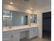 Bathroom with double sinks and a large mirror at 16954 W Molly Ln, Surprise, AZ 85387