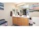 Neutral bathroom with dual sinks, warm wood cabinets, and a framed mirror at 1765 N Agave St, Casa Grande, AZ 85122