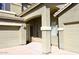 Inviting front entrance with covered porch, columns, and a three car garage on a stucco home at 1765 N Agave St, Casa Grande, AZ 85122