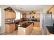 Bright kitchen featuring stainless appliances, granite countertops, tile backsplash, and wooden cabinets at 1765 N Agave St, Casa Grande, AZ 85122