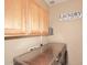 Well-organized laundry room featuring modern, front-load washer and dryer with cabinetry above at 1765 N Agave St, Casa Grande, AZ 85122