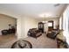 Charming living room featuring elegant brown furnishings, ample windows, and an inviting open-concept layout at 1765 N Agave St, Casa Grande, AZ 85122