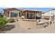 Backyard view of covered patio with sitting and dining spaces at 19437 N Guardian Ln, Surprise, AZ 85387