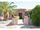 Well manicured landscaping adorns the walkway to this tan home at 19437 N Guardian Ln, Surprise, AZ 85387