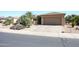 Attached two car garage with long driveway and desert landscaping at 19437 N Guardian Ln, Surprise, AZ 85387