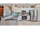 Inviting kitchen showcasing stainless steel appliances, granite countertops, white cabinetry, and an open layout at 19437 N Guardian Ln, Surprise, AZ 85387