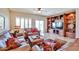 Living room with leather furniture and decorative built-ins at 19437 N Guardian Ln, Surprise, AZ 85387