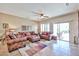 Spacious living room with tile flooring and outdoor access at 19437 N Guardian Ln, Surprise, AZ 85387