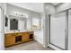 Bright bathroom featuring a large mirror, shower stall and soaking tub at 2015 S 80Th Ln, Phoenix, AZ 85043