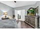 Spacious bedroom featuring laminate wood floors and a large television at 2015 S 80Th Ln, Phoenix, AZ 85043