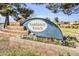 Sundance Ranch community sign surrounded by colorful flowers and greenery at 2015 S 80Th Ln, Phoenix, AZ 85043