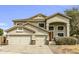 Inviting two-story home featuring a three-car garage and stucco siding at 2015 S 80Th Ln, Phoenix, AZ 85043