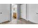 Hallway with tiled floors leading to bathroom with vanity and shower at 2015 S 80Th Ln, Phoenix, AZ 85043