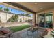 Inviting covered patio with comfortable seating and a well-manicured lawn perfect for outdoor relaxation and entertaining at 20646 W Delaney Dr, Buckeye, AZ 85396