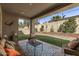 Inviting covered patio complete with outdoor seating and adjacent green space for relaxation and entertainment at 20646 W Delaney Dr, Buckeye, AZ 85396