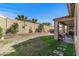 Lush backyard with a beautiful patio, block wall with planters, and a perfect outdoor oasis at 20646 W Delaney Dr, Buckeye, AZ 85396