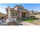 Backyard with patio, table and six chairs, and nice landscaping, perfect for relaxing and entertaining guests at 20646 W Delaney Dr, Buckeye, AZ 85396