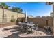 Outdoor dining area with table and six chairs and a patio, perfect for entertaining in the backyard at 20646 W Delaney Dr, Buckeye, AZ 85396