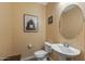 Clean, well-lit powder room featuring a pedestal sink and tiled flooring at 20646 W Delaney Dr, Buckeye, AZ 85396