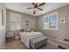 Bright bedroom with a ceiling fan, natural light, and neutral colored decor at 20646 W Delaney Dr, Buckeye, AZ 85396