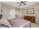 Cozy bedroom with a full bed, dresser, and a view into an adjoining room, offering comfortable living space at 20646 W Delaney Dr, Buckeye, AZ 85396