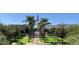 View of a community green space featuring palm trees, walking paths, and a vibrant American flag at 20646 W Delaney Dr, Buckeye, AZ 85396