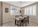 Cozy dining room with shuttered windows, wood floors and modern lighting at 20646 W Delaney Dr, Buckeye, AZ 85396