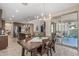 Bright open-concept dining room with wood floors and access to kitchen and living area at 20646 W Delaney Dr, Buckeye, AZ 85396