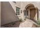 Inviting front entrance with an arched entryway and well-manicured plants for added curb appeal at 20646 W Delaney Dr, Buckeye, AZ 85396