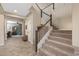 Inviting entryway with tiled flooring, staircase, and decorative wood accents at 20646 W Delaney Dr, Buckeye, AZ 85396