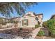 Attractive home featuring desert landscaping, a paved walkway, and a neutral color scheme at 20646 W Delaney Dr, Buckeye, AZ 85396