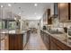 Well-lit kitchen area showcasing a large island, modern cabinetry, and open layout to the dining space at 20646 W Delaney Dr, Buckeye, AZ 85396