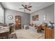 Cozy living room featuring a ceiling fan, comfortable sofa, and eclectic decor at 20646 W Delaney Dr, Buckeye, AZ 85396