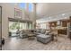 Open-concept living room with high ceilings, large windows, and modern furnishings at 20646 W Delaney Dr, Buckeye, AZ 85396