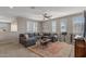 Cozy living room with a comfortable gray sectional sofa and neutral decor at 20646 W Delaney Dr, Buckeye, AZ 85396