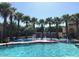 Fun splash pad at the community pool surrounded by swaying palm trees, offering a refreshing oasis for families at 20646 W Delaney Dr, Buckeye, AZ 85396