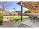 Covered patio with outdoor seating, artificial grass, and a view of the landscaped backyard at 2130 E Knudsen Dr, Phoenix, AZ 85024